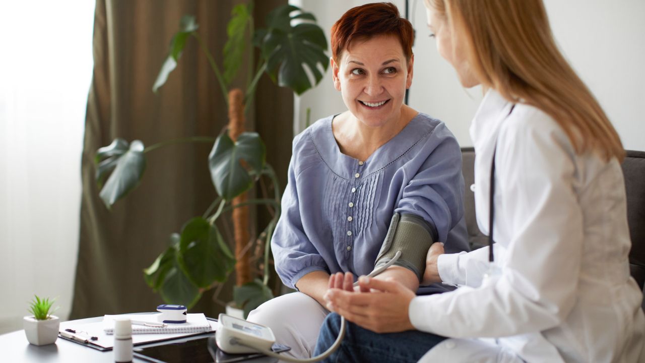 smiley-covid-recovery-center-female-doctor-checking-elder-patient-s-blood-pressure smiley-covid-recovery-center-female-doctor-checking-elder-patient-s-blood-pressure